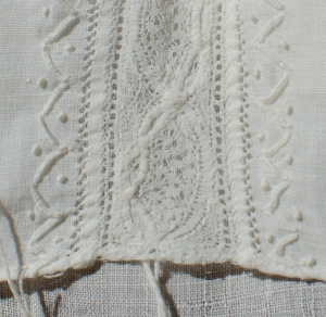 Closeup of lace insertion on cap.